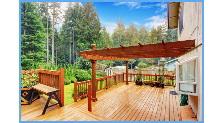 pergola attached to a deck and house in a backyard